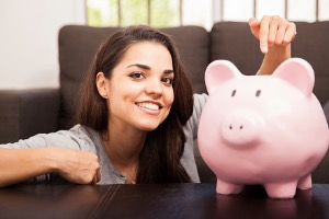 Woman pointing to piggybank 